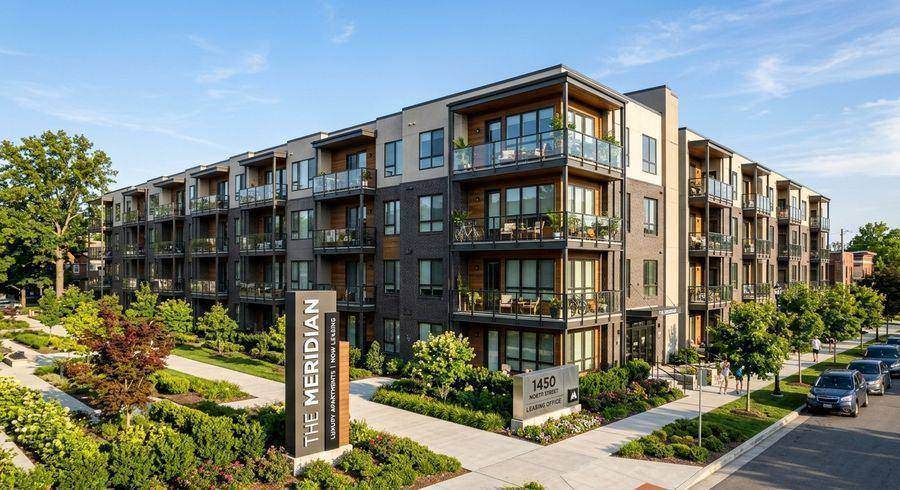 Residential apartment building exterior with controlled entry and numbered unit doors